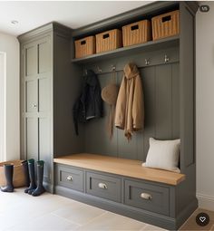 a coat rack with two coats hanging on it and some shoes in the foreground