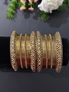 metal bangle set- 2.4 ,2.6, 2.8 set includes- 4kadas, 18 plain bangles, 4 AD bangles Traditional Gold Jeweled Bracelets, Gold Jeweled Bangle For Festivals, Heavy Adjustable Bangle, Gold Festive Jewelry With Bling, Traditional Stackable Metal Jewelry, Adjustable Heavy Round Bangle, Festive Metal Bangle For Parties, Festive Round Metal Bracelets, Festive Gold Bling Jewelry