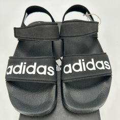 Adidas Adilette Sandals Color: Black/White Size: 1 Youth Condition: New In Box Casual Open Toe Sandals With Adidas Logo, Adidas Open Toe Sandals With Logo, Adidas Logo Synthetic Sandals With Round Toe, Summer Black Adidas Sandals, Black Slip-resistant Sandals With Round Toe, Black Non-slip Slide Sandals, Adjustable Non-slip Black Sandals, Black Adjustable Non-slip Sandals, Spring Black Slip-resistant Sandals