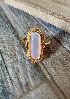 Vintage inspired, adjustable, natural mother of Pearl shell, electroplated, 18k over brass. Adjustable Gold Moonstone Brass Ring, Adjustable Gold Moonstone Ring In Brass, Elegant Gold Moonstone Ring In Brass, Gold Cabochon Moonstone Ring, Adjustable Oval Gold Moonstone Ring, Adjustable Gold Oval Moonstone Ring, Bohemian Gold Oval Moonstone Ring, Gold Oval Moonstone Bohemian Ring, Adjustable Gold Moonstone Cabochon Ring