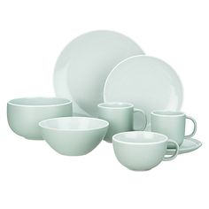 a set of white dishes with cups and saucers