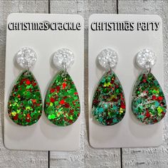 the christmas crackle earrings are in green and red colors with glitters on them