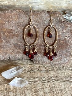 Gold filled chandelier earrings with faceted garnet gemstones Gold Garnet Dangle Earrings, Faceted Garnet Drop Earrings, Garnet Faceted Drop Earrings, Elegant Garnet Briolette Earrings, Elegant Briolette Garnet Earrings, Faceted Garnet Earrings In Gold, Gold Faceted Garnet Earrings, Gold Garnet Faceted Earrings, Garnet Dangle Birthstone Jewelry