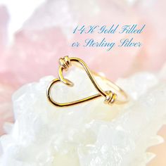 This sideways heart ring features an open heart design in 14K gold filled or sterling silver, perfect for any occasion. A thoughtful Mother's Day present, this custom heart outline ring makes a beautiful gift for women who love elegant, minimalist jewelry. ✦100% Handcrafted ✦ High quality 14K gold filled, 14K rose gold filled or sterling silver argentium ✦ Ring arrives in either a pink microfiber suede envelope/pouch or a blue/green drawer cardboard box as seen in the last image of this listing. ✦ Ready to ship in one business day ✦ Average shipping time (US/Canada/UK) three to five business days ✦ Tracking Available ✦Band  Width--1mm Color--gold, rose gold or silver Shape--round Texture--smooth Material--14K gold-filled, 14K rose gold-filled or sterling silver argentium wire Gauge--20 ✦US 14k Gold Filled Jewelry For Valentine's Day Wedding, Gold Heart Ring In Sterling Silver As Gift, 14k Gold Filled Jewelry For Wedding On Valentine's Day, Dainty Gold Midi Rings For Valentine's Day, Gold Midi Rings For Valentine's Day, Delicate Gold Heart Midi Rings, 14k Gold Stackable Rings With Heart Charm For Gift, Gold Heart Ring For Promise, Mother's Day, Adjustable Gold Heart Ring For Mother's Day