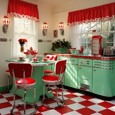 an old fashioned kitchen with red and white checkered flooring, green cabinets, and retro appliances