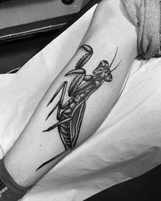 a black and white photo of a person with a tattoo on their arm holding a knife