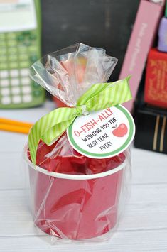 a plastic cup filled with candy sitting on top of a table