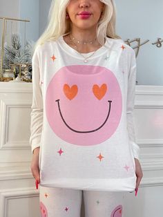 Our Hearts and Charms Smiley PJ Set in white is super soft and comfy to lounge around! Hearts act as the smiley face eyes on the top. Also available in light pink! fit: these RUN SMALL - size up 1 size more than your normal model normally wears a small and is wearing a medium in this photo White Heart Print Sleepover Set, Printed White Sleepover Sets, Cute White Sleepwear With Character Print, Spring Sleepwear With Heart Print For Sleepover, White Heart Print Sleepwear For Spring, Pajama Fashion, Heart Face, White Heart, Pj Sets