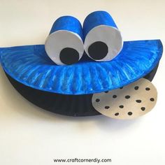 a blue paper plate with two eyes on it