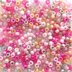 pink, white and gold beads are arranged together