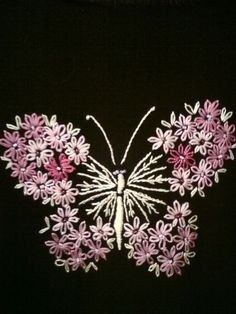 an embroidered butterfly with pink and white flowers