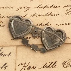 "The listing is for a Victorian English Mizpah Brooch. The brooch is in the shape of two joined hearts brooch with hand engraved and applied leaf decoration. The brooch has the word MIZPAH applied to the heart and has an engraved prayer \" The Lord Watch Between Me and Thee When We Are Absent One From Another\" (from Genesis 31:49). Weighs: 3.2 grams Measurement: It measures 0.8055 inches long and 1.5515 inches wide. Marks: Anchor Lion d marks. A.G.G. makers mark (possibly for Alfred George Grif Antique Heart Brooch For Wedding, Antique Heart-shaped Wedding Brooch, Heirloom Engraved Brooches For Gifts, Antique Heart-shaped Brooch For Gift, Antique Heart-shaped Brooches As Gifts, Antique Heart-shaped Brooches For Gifts, Collectible Vintage Heart-shaped Brooch, Vintage Heart-shaped Collectible Brooch, Vintage Heart Shaped Collectible Brooch