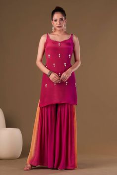 Crimson ombre sharara with hues of fuchsia, yellow and purple. Paired with hand embroidered sleeveless pink kurta featuring pearl detailing on neck line and organza dupatta with scalloped edges, cowries and pearl tassels.
Components: 3
Pattern: Embellished
Type Of Work: Pearls, Shells, Cowries
Neckline: Sweetheart Neck
Sleeve Type: Sleeveless
Fabric: Viscose Crepe
Color: Pink
Other Details: 
Attached inner lining
Approx Weight: 2 kgs
Length:
Kurta: 34inches
Sharara: 43inches
Model Height: 5ft 7i Pearl Tassels, Pink Kurta, Cowrie Shells, Yellow And Purple, Organza Dupatta, Cowrie Shell, Scalloped Edges, Sweetheart Neck, Set For Women