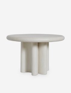 a white table with three columns on it's sides and one column in the middle