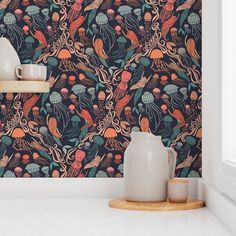 the wallpaper in this kitchen is colorful and has an octopus pattern on it, as well as two vases