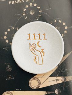 a close up of a white frisbee on top of a book with gold lettering