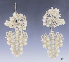 Presented is a lovely pair of Victorian seed pearl bridal earrings. These pieces date to around the 1850-1870 and are of American make. The earrings have 10 karat gold backs, for pierced ears. The earrings consist of seed pearls with larger round pearls sewn onto a mother-of-pearl backing, forming a design of a cluster of grapes. Seed pearl jewelry in this delicate, hand-sewn style was often made and worn specifically as bridal jewelry for a wedding, and this suite would be a lovely addition to Antique Wedding Earrings With Historical Design, Victorian Style Formal Pearl Drop Earrings, Victorian Baroque Earrings For Formal Occasions, Victorian Baroque Earrings, Victorian Pearl Earrings For Anniversary, Victorian Style Pearl Earrings For Evening, Ornate Historical Wedding Earrings, Ornate Historical Design Earrings For Wedding, Vintage Historical Design Earrings For Wedding