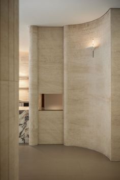 an empty room with marble walls and floor