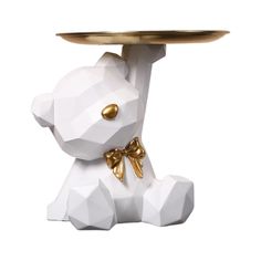 a white and gold dog with a tray on its head is shown in front of a white background