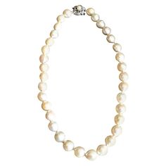 This vintage women's cultured pearl choker necklace is presumed to have been made in North America in circa 1950 in the Baroque style. The pearls are of a good size and well matched with a strong iridescent luster. The pearls are individually hand knotted and the disc styled clasp is made of 14-karat white gold with a pearl accent. There does appear to be a possible maker's mark on the back of the clasp, but considerably illegible so the maker will be noted as 'unknown'. The entire strand with t Disc Style, Women Choker Necklace, Style Baroque, Pearl Choker Necklace, Baroque Fashion, Pearl Choker, Cultured Pearls, Makers Mark, Pearl Necklace