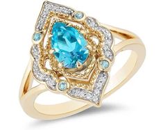 a gold ring with an oval blue topazte surrounded by small white and yellow diamonds