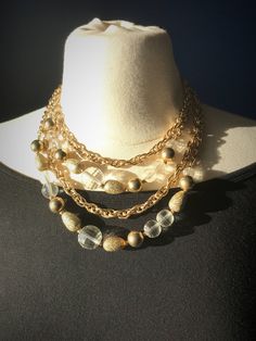 "Gorgeous & Fun Vintage Signed Coro Multi-strand Beaded Choker Necklace. Two strands of gold tone Prince of Wales chain and Two strands of gold tone link chain with clear, round faceted beads and gold tone beads. Four (4) strands in total. Perfect to dress up daytime attire or to go with formal wear. Would make a fabulous New Year's necklace!  Necklace adjusts from choker-length at 14.5\" to princess length at 18\" by hooking onto different links in the tasseled backdrop chain.   Clear vintage p Choker Necklace Gold, Statement Bib Necklace, Beaded Choker Necklace, Hanging Earrings, Prince Of Wales, Multi Strand Necklace, Plastic Beads, Beaded Choker, Strand Necklace