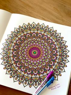 a coloring book with a pen on top of it