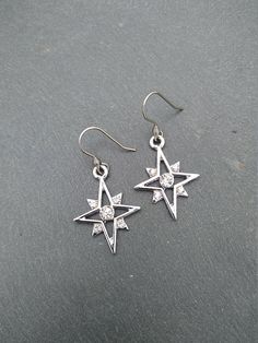 PLEASE read my shop announcement before placing an order so you know what to expect right now. Plus, when ordering from outside Europe, don't forget to provide a phone number for the courier to ensure the fastest and smoothest delivery. Elegant dangle rhinestone starburst earrings, comfortable and lightweight Stainless steel earhooks Stainless steel hooks, won't rust, change its tone or cause you any allergies More Magical celestial jewelry here: https://www.etsy.com/shop/ValkyriesSong?ref=selle Cubic Zirconia Star Charm Dangle Jewelry, Cubic Zirconia Dangle Jewelry With Star Charm, Star-shaped Cubic Zirconia Jewelry With Matching Earrings, Starburst Cubic Zirconia Jewelry Gift, Celestial Silver Sparkling Earrings, Sparkling Sterling Silver Star Jewelry, Cubic Zirconia Drop Earrings With Star Charm, Silver Star-shaped Earrings With Ear Wire, Silver Stainless Steel Jewelry With Star Charm