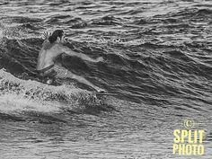 a man riding a wave on top of a surfboard