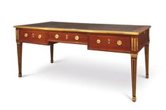 an antique desk with two drawers on one side and gold trimmings on the other