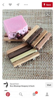 several wooden sticks and a soap bar sitting on top of a cloth covered tablecloth