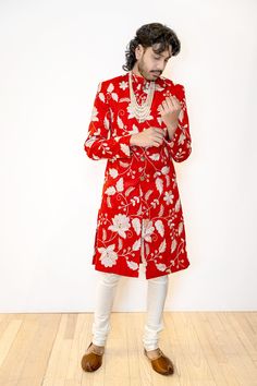 Make a lasting impression in our BRIJ Red and White Wedding Sherwani. Made with a beautiful embroidered dupioni, this sherwani features a stunning white and gold floral pattern for a modern twist on a classic Indian groom look. The perfect choice for a sophisticated but bold Indian groom. Details Thread and Sequin Embroidered 100% Polyester Dupioni Lined in Crepe-back Satin Dry Clean Only Item #102601-24-04 Made in NYC - Ethically designed + produced in New York City Elegant Sherwani With Floral Embroidery, Formal Sherwani With Floral Embroidery For Diwali, Traditional Sherwani With Floral Embroidery, Festive Bandhgala With Floral Embroidery For Wedding, Festive Floral Embroidered Bandhgala For Wedding, Ceremonial Bandhgala With Floral Embroidery, Festive Floral Embroidered Sherwani For Diwali, Festive Diwali Sherwani With Floral Embroidery, Bollywood Style Sherwani With Floral Embroidery For Festivals