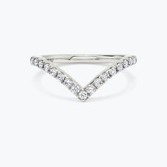 a white gold ring with diamonds in the middle and a v shaped band on top