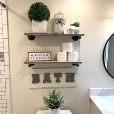 a white toilet sitting in a bathroom next to a walk in shower under a mirror