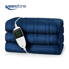 an electric heated blanket with thermometer on it and three blue towels stacked next to each other