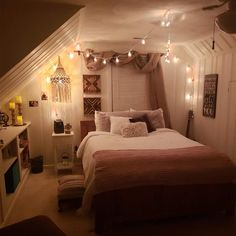 a bedroom with lights strung from the ceiling