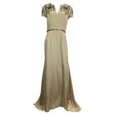 Naeem Kahn Heavily Embellished Champagne Silk Gown-Size 10 This spectacular Naeem Kahn creation is made of a wonderful champagne colored heavy silk and is lined in an additional layer of a lighter colored silk. The gown has a short cap sleeve and is heavily embellished in the upper are of the bodice front and back. The embellishment is made of a combination of multi sized and shaped sequin, paillettes and rhinestones that form a floral pattern. The gown has a rounded neckline with a small V down the center, fitted to the waistline where there is a 1” sequin/rhinestone detail and then the skirt goes out in an A line and has a fishtail in the back. There is a 23” back center zipper with a hook and eye closure in the top. This gown is in very good condition with only some minor wear as well a Naeem Khan, Color Champagne, Silk Gown, Champagne Color, Cap Sleeves, Evening Dresses, Bodice, Champagne, Going Out