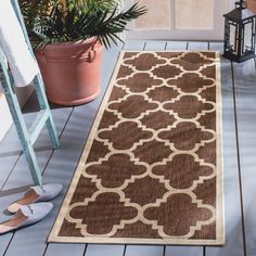 a brown and white rug sitting on top of a wooden floor next to a door