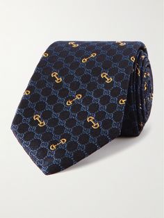 Gucci's tie is embroidered with a monogram interspersed with gold-tone chain links. In a somewhat slim 7cm width, it's spun from silk in blues that'll complement a range of suiting. Luxury Gold Suit And Tie Accessories For Formal Occasion, Designer Suit And Tie Accessories For Workwear, Designer Workwear Ties, Designer Ties For Black Tie Events, Luxury Gold Tie For Formal Occasions, Luxury Business Suit And Tie Accessories, Designer Formal Suit And Tie Accessories, Designer Semi-formal Suit And Tie Accessories, Designer Ties For Formal Occasions