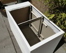 an open box sitting on top of a sidewalk