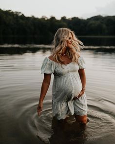 a pregnant woman standing in the water