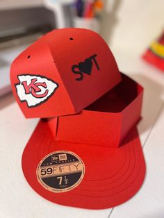 the kansas chiefs hat is made out of red paper and sits on top of a cardboard box