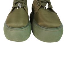 Attico 'Selene' combat boots in green nylon with a lace up closure with green laces, silver grommet and charm hardware, and a green platform sole. Brand = Attico Size = 37EU Condition = 8/10, Very good. Light scratches in nylon toe, some wear to soles. Material = Nylon Hardware = Silver Platform Height = 2" SKU = 19963-32 Trendy Green Boots With Lug Sole, Trendy Green Lace-up Boots, Casual Green Ankle Platform Boots, Green High-top Boots With Vibram Sole, Green Ankle Platform Boots, Green Platform Ankle Boots, Green Platform, Silver Platforms, Green Lace