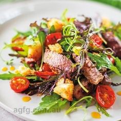 a white plate topped with meat and veggies