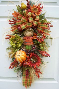 a fall wreath hanging on the front door