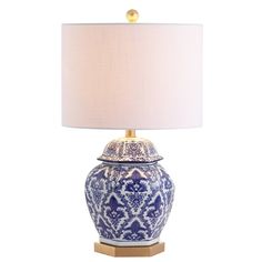 a blue and white table lamp with a gold base on a white background the light is turned off