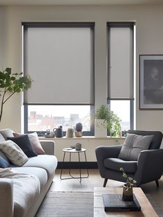 a living room filled with furniture and windows covered in roller shade blind shades on the windows