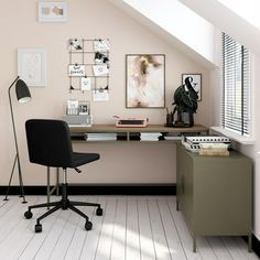 an office with a desk, chair and pictures on the wall above it's desk