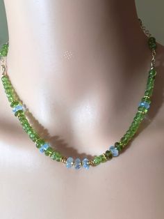 Beautiful, bright, apple-green peridot and sky blue topaz necklace.   Gem-heavy, 16.5" long. All beads are Balinese 18k over Sterling silver.   Fancy cable chain and clasp are US gold filled.   The chain is woven with peridot. Green Rondelle Gemstone Necklace, Handmade Green Peridot Jewelry, Green Peridot Necklace For May Birthstone, Peridot Beads Jewelry, Peridot Gemstone Bead Necklace For Gift, Handmade Lime Green Peridot Jewelry, Handmade Green Peridot Necklaces, Green Peridot Jewelry With Gemstone Beads, Peridot Beaded Necklace