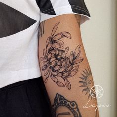 a woman's arm with tattoos on it